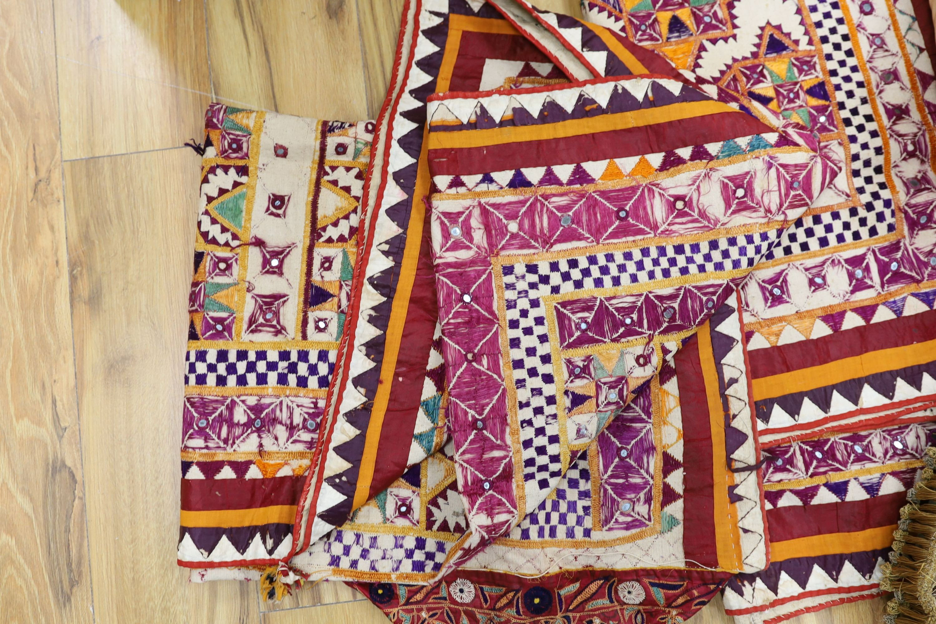 An Indian embroidered cover and cushions